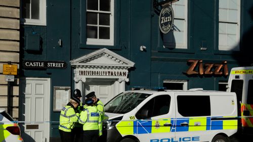 Police officers stand outside a Zizzi restaurant in Salisbury, near where Skripal fell ill. (AAP)