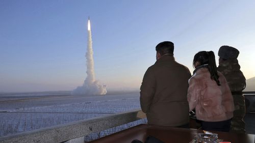 North Korean leader Kim Jong Un watches missile launch.