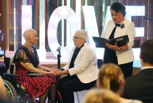 The celebrant officiates the couple's legal marriage ceremony. (AAP)