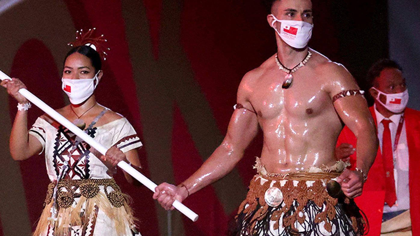 Pita Taufatofua leads the Tongan team out at the Tokyo Olympics.