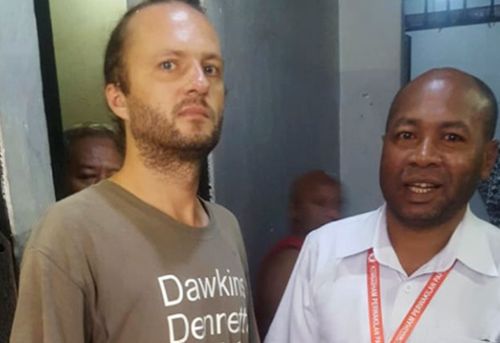 Polish national Jakub Skrzypski, left, who is detained and charged with treason on accusation of assisting Papuan independence supporters and separatist fighters talks with the head of Papua Representative Office of the National Human Rights Commission Frits Ramandey.