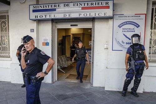 Police wait for the arrival of French President Emmanuel Macron at the central police station in Noumea, New Caledonia, Thursday, May 23, 2024.