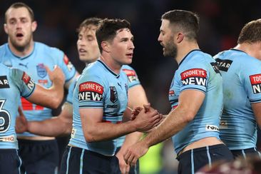 Mitchell Moses and James Tedesco of the Blues celebrate winning game three of the State of Origin series.