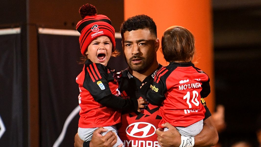 Richie Mo&#x27;unga of the Crusaders runs out with his children.