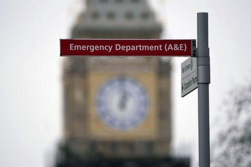 An Emergency Department sign at St Thomas Hospital is displayed back-dropped by the Elizabeth Tower of the Houses of Parliament, known as Big Ben, in London, Thursday, Jan. 6, 2022. 