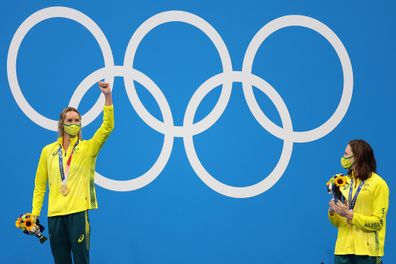 Gold medalist Emma McKeon of Team Australia and bronze medalist Cate Campbell of Team Australia react on the podium during the medal ceremony for the Women's 100m Freestyle Final.