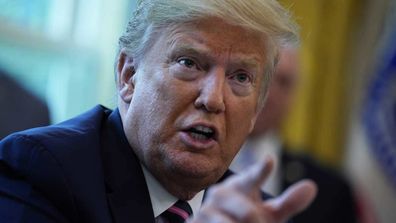 President Donald Trump speaks during the signing of a coronavirus aid package.