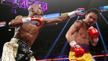 Mayweather in the ring with Manny Pacquiao. (Getty Images)