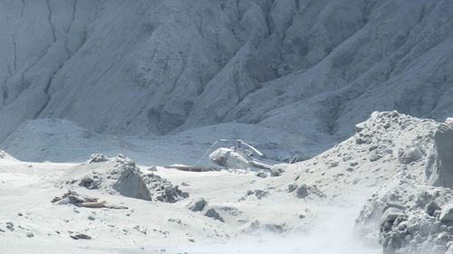 A tourist's image of a helicopter in ruins following the White Island eruption.