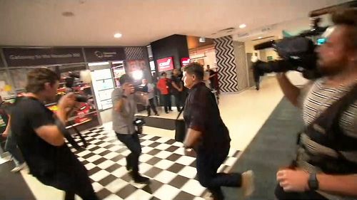 Ms Lawrence rushed through Newcastle Airport's arrivals terminal, causing one photographer to lose his footing and fall.