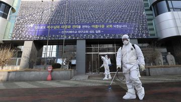Health workers disinfect the footpath outside the Shincheonji Church of Jesus, a cult in South Korea.