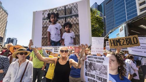 Supporters of Tamil asylum seekers Nadesalingam, Priya and their Australian-born children Kopika and Tharunicaa are seen at a rally outside Brisbane City Hall, Brisbane.