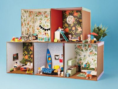<p>Cardboard apartment block ...</p>
<p>1. For each apartment, cut five cardboard squares for the floor and four walls (these ones are 30cm squares).</p>
<p>2. Cover each in gift wrap on one side (this is your wallpaper) and trim.</p>
<p>3. Use coloured duct tape to tape your floor and five walls together into an open box.</p>
<p>4. Stack your apartments together and decorate!</p>