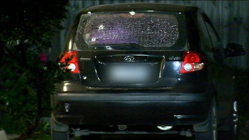 Bullet holes can be seen in the back window of a Hyundai Getz parked outside. Picture:9NEWS
