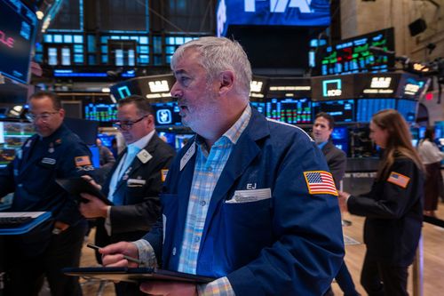 Traders work on the floor of the New York Stock Exchange on March 14, 2025