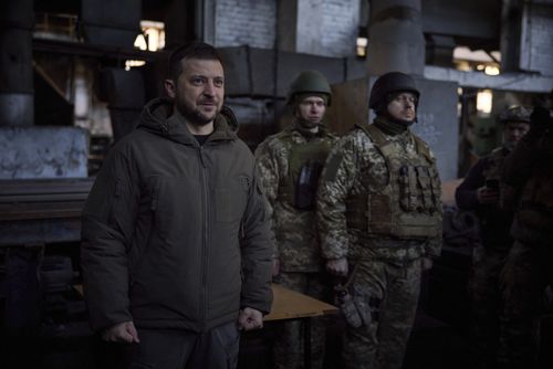 Ukrainian President Volodymyr Zelenskyy, left, speaks to soldiers at the site of the heaviest battles with the Russian invaders in Bakhmut, Ukraine, Tuesday, Dec. 20, 2022
