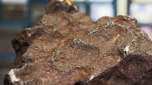 A rock that was used as a doorstop for decades at a farm in Michigan, US has been identified as a meteorite valued about US$100,000 (A$141,000).