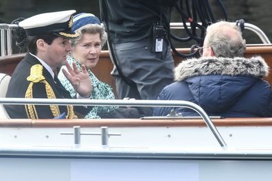 Imelda Staunton and other cast members are seen on a boat made to look like a Royal yacht tender in the harbour during filming for the Netflix series "The Crown" on August 2, 2021 in Macduff, Scotland.