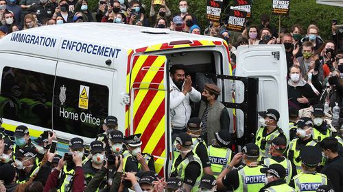 Two men are released from an Immigration Enforcement police van in Glasgow.