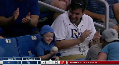 Adorable moment young boy throws baseball to field after lucky 'catch'