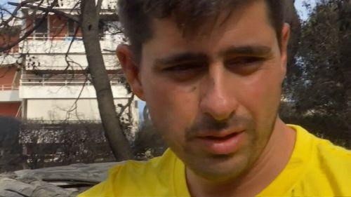 Panagiotis Dagalos took his baby and fled to the safety of the ocean. Picture: 9NEWS