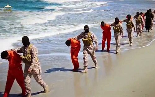 Members of an Islamic State affiliate walk captured Ethiopian Christians along a beach in Libya, before being executed (AAP)