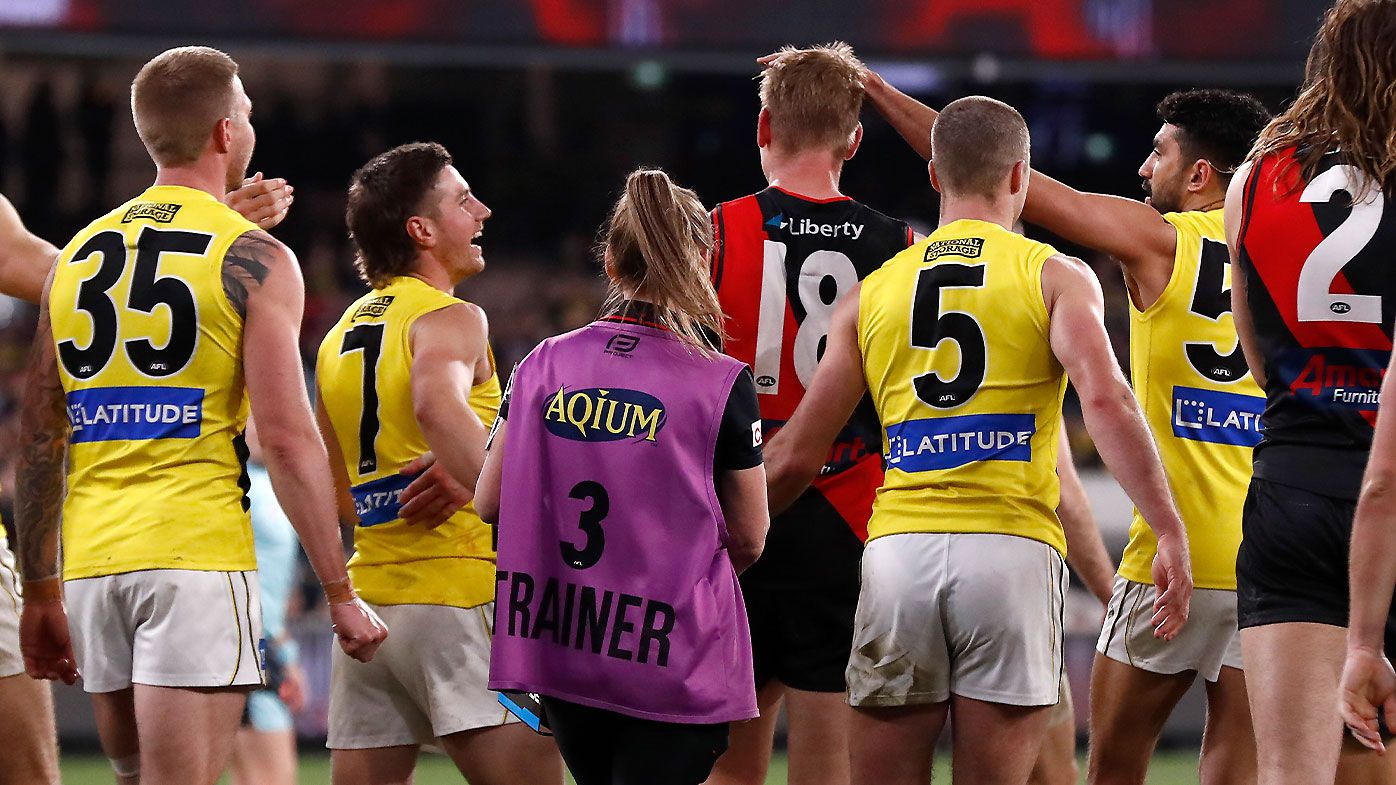 Michael Hurley was mobbed by both Essendon and Richmond players after the final goal of his career