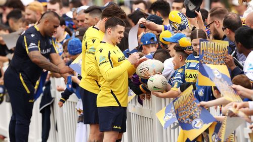 Reed Mahoney and Eels teammates sign autographs during a fan day and training session at Kellyville Park to kick off grand final week on Monday.