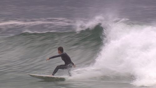 The closures did not stop some surfers from hitting the surf (9NEWS)