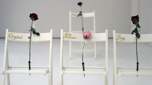 A pink rose was placed on a chair in memory of an unborn baby killed in the massacre. (AAP)