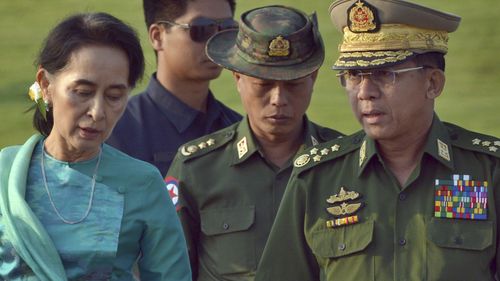 In this May 6, 2016, file photo, Aung San Suu Kyi, left, Myanmar's foreign minister, walks with senior General Min Aung Hlaing, right, Myanmar military's commander-in-chief, in Naypyitaw, Myanmar.