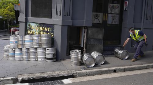 As businesses prepare to reopen in Sydney, there are concerns about what coming into contact with a case would mean for staff. Sydney lockdown ending pub bar kegs on September 21, 2021. (AP Photo/Mark Baker)