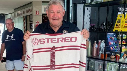 Manly legend Graham Eadie holds up his 1978 grand final jersey.