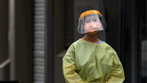 A healthcare worker outside Sydney's Royal Prince Alfred Hospital. coronavirus covid-19