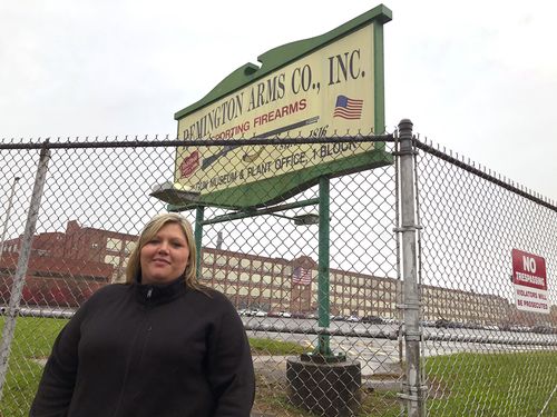 Jacquie Sweeney stands outside the Remington firearms factory in Ilion, New York. Ms Sweeney and her husband were among almost 600 workers fired by the company this week, a few months after Remington Outdoor Co. sought bankruptcy protection for the second time in two years