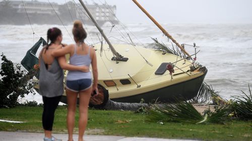 A boat is seen washed ashore at Airlie Beach after Cyclone Debbie hit Queensland's far north coast yesterday as a category 4 cyclone, causing widespread damage. (AAP)