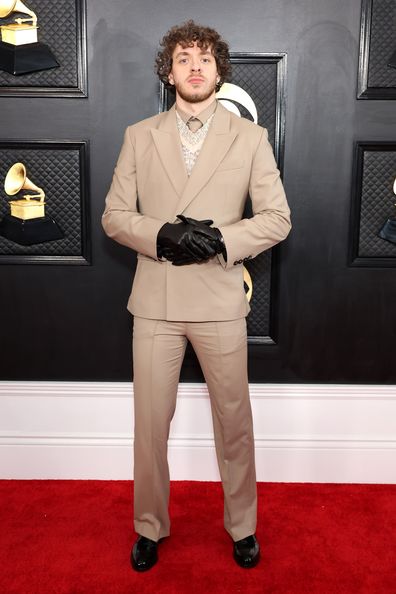 Jack Harlow lived up to his 'cool' persona in a beige pantsuit and leather gloves.