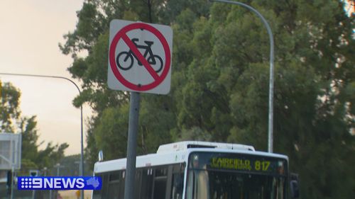 A no bike sign in Bossley Park near a bus. 