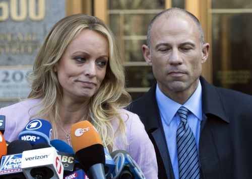 Adult film actress Stormy Daniels, left, stands with her lawyer Michael Avenatti as she speaks outside federal court, in New York. The Justice Department says Avenatti, made "misrepresentations" in a bankruptcy case involving his former law firm that owes more than $440,000 in unpaid federal taxes. Avenatti said Wednesday, July 4, 2018, he doesn't owe any money personally and called the court filing "politically motivated." (AP Photo/Mary Altaffer, File)