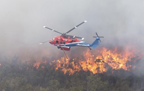 Chopper flying overhead of bushfire