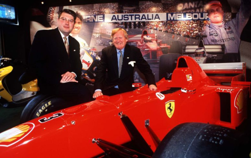 Mr Walker with a Ferrari during the 1999 announcement that Melbourne would host the 2000 Formula One Grand Prix. (Getty)