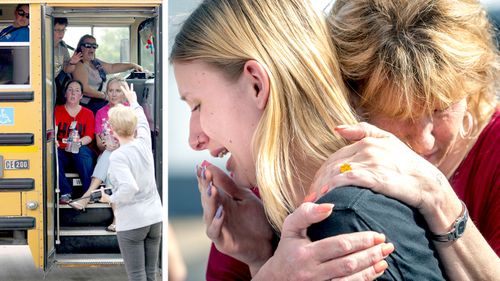 Staff members sit on a bus after a shooting at Santa Fe High School (left), and student Dakota Shrader is comforted by her mother Susan Davidson (right). (AAP)