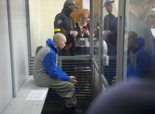 Russian army's Sergeant Vadim Shishimarin, of unit 32010 of the 4th Tank Division of Moscow region, sits in cage during a court hearing in Kyiv, Ukraine, Friday, May 13, 2022 
