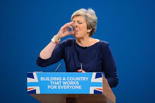 May takes a sip of water during her rallying conference speech. (AAP)