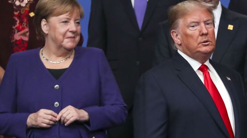 Chancellor of Germany Angela Merkel and US President Donald Trump stand onstage during the annual NATO heads of government summit on December 4, 2019 in Watford, England