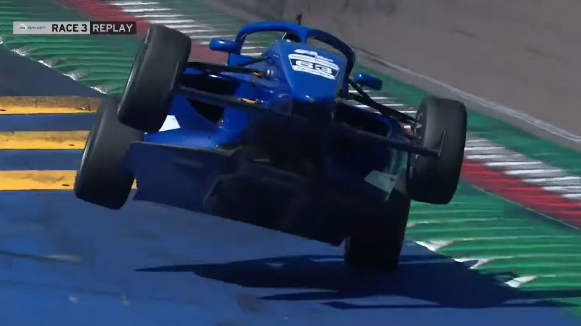 The moment an F4 car flies into the air after striking a sausage kerb.