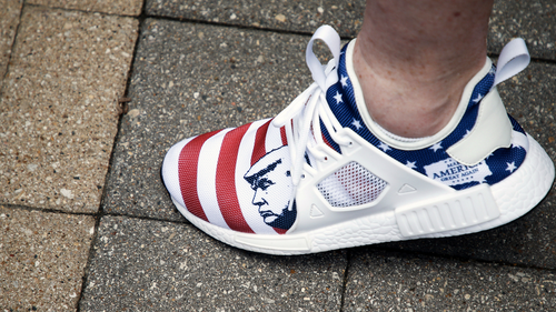 A protester wears a pair of shoes with President Donald Trump on them during a protest against the proposed citywide mask ordinance being voted on by Tulsa City Council at Tulsa City Hall on Wednesday, July 15, 2020. IAN MAULE/Tulsa World