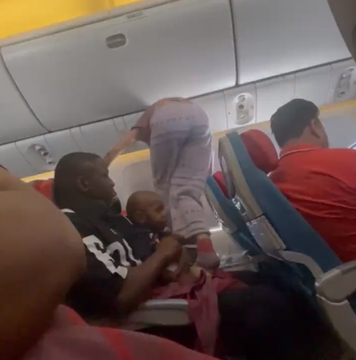 Woman divides opinion after climbing over passenger holding their child on a plane