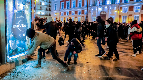 Demonstrators broke a glass during clashes with the police following a protest condemning the arrest of Mr Hasel in Madrid, Spain.