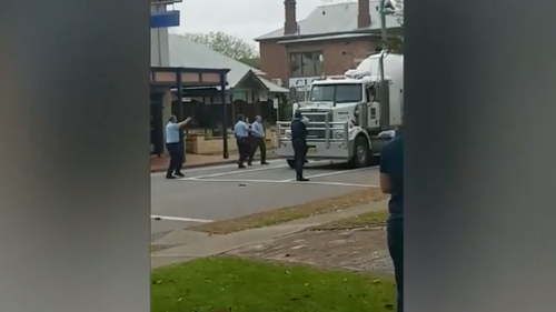 Video has emerged of police surrounding the stolen struck, aiming their weapons at the windscreen. 